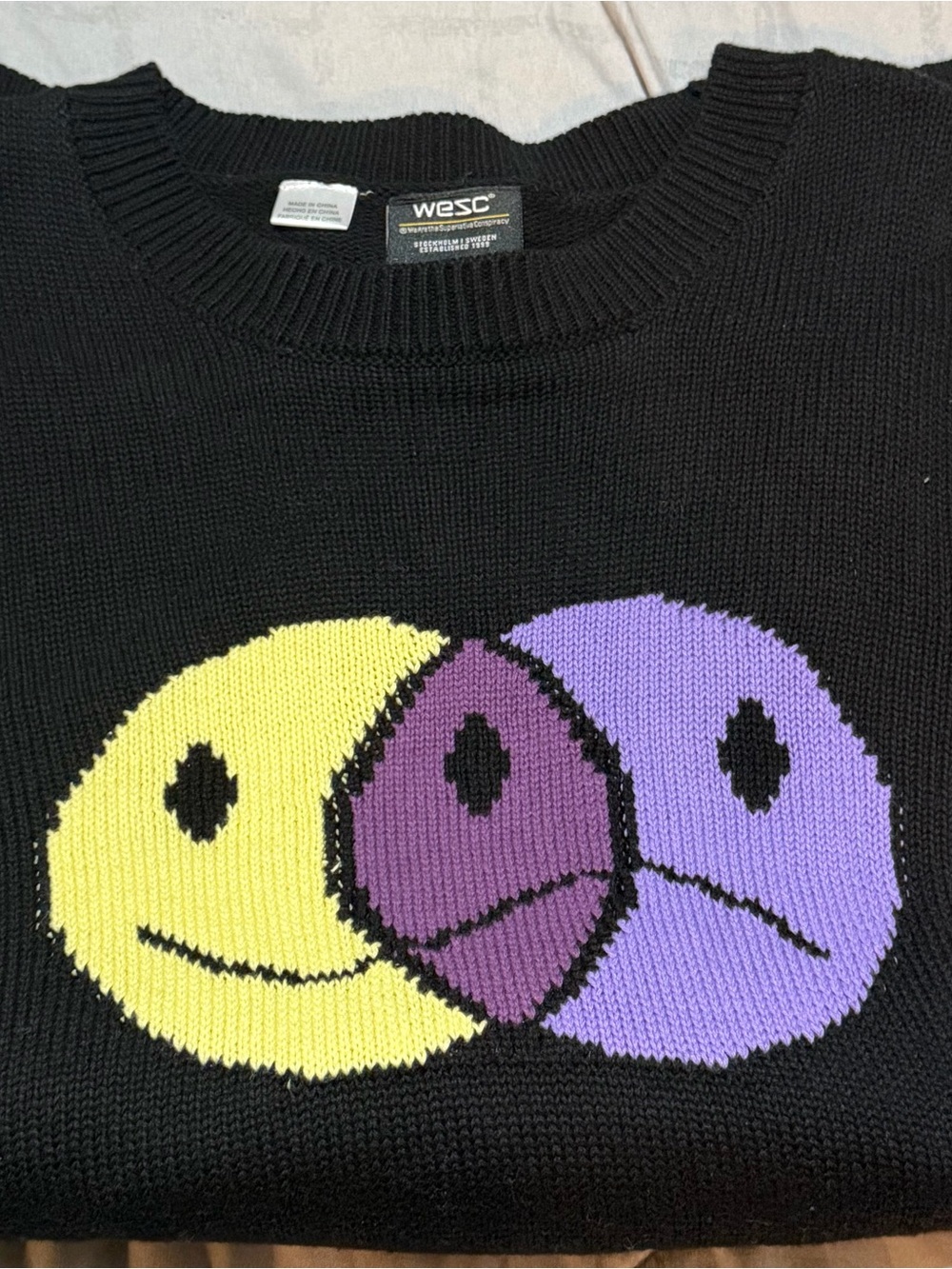 WeSC Black Crewneck Sweater with Yellow and Purple Smiley Design